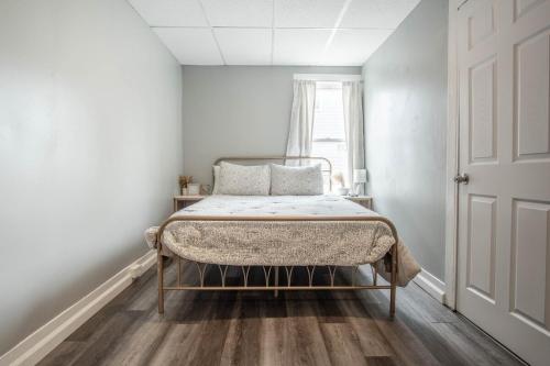 a bed in a white room with a window at Cozy Croghan Apartment in Croghan