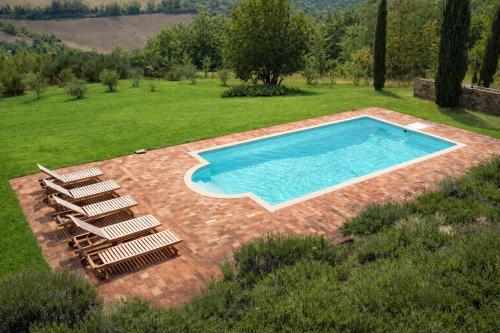 a swimming pool with a group of chairs around it at VILLA ADELE - Ville Carborello in Crispiero
