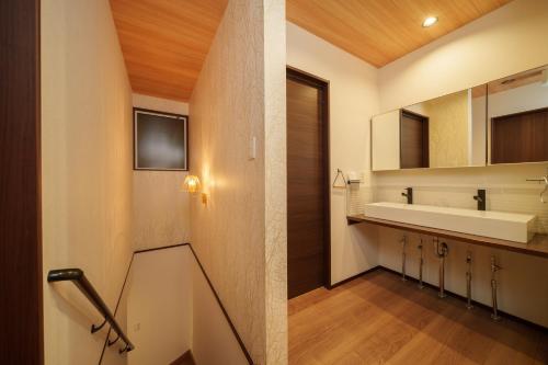 a bathroom with a sink and a mirror at LilyHouse in Beppu