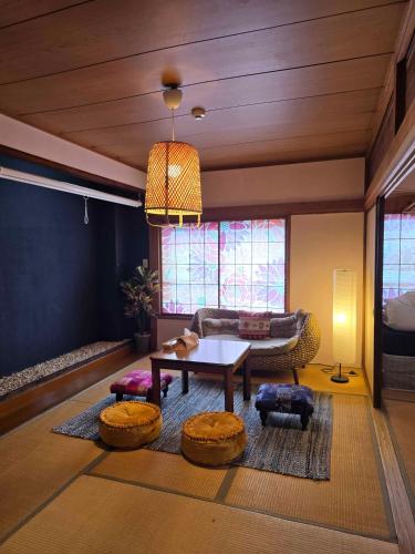a living room with a table and a couch at Kaido Yuzawa Onsen Hostel in Yuzawa