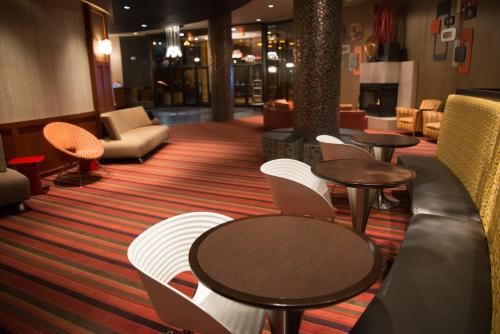 a lobby with tables and chairs in a hotel at Radisson Hotel Duluth-Harborview in Duluth