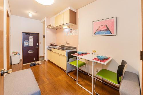 a small kitchen with a table and a sink at Happy House NIshi-Koiwa Keisei Koiwa Station 5min in Tokyo