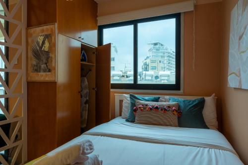 a small bedroom with a bed and a window at Johny's Spot in Larnaca in Larnaca