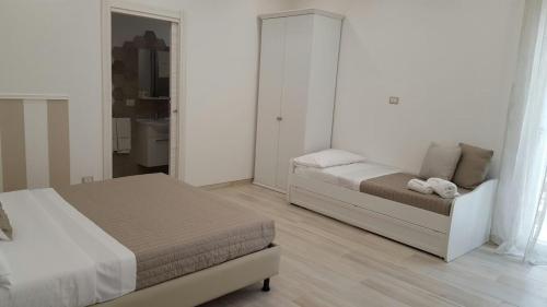 a small bedroom with a bed and a couch at Finestre sul Borgo in Cassano delle Murge