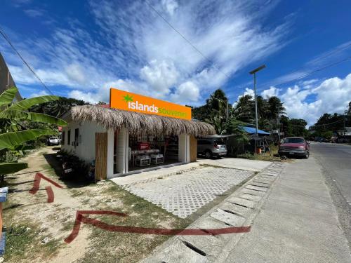a restaurant with a sign on the side of the road at Monera's Native Cabin in San Juan