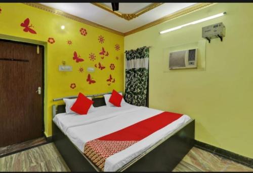 a bedroom with a bed with red pillows at RROOMS Eco Hotel Best in Lucknow