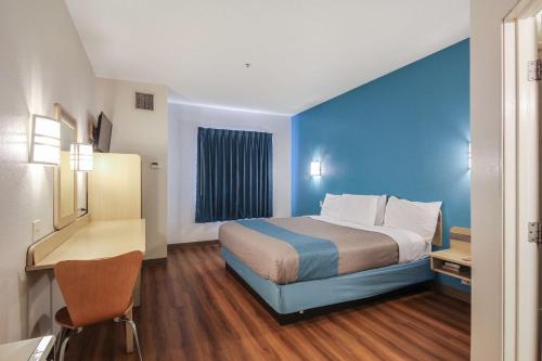a hotel room with a bed and a desk at Motel 6 New Braunfels in New Braunfels
