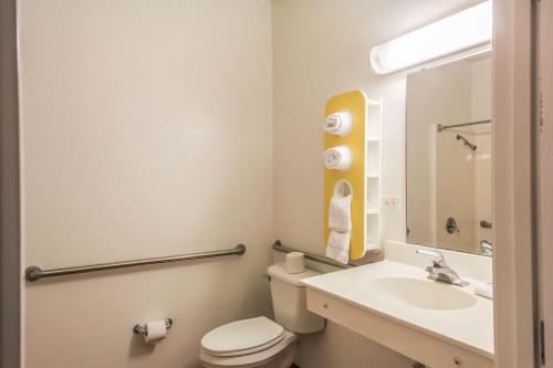 a bathroom with a white toilet and a sink at Motel 6 New Braunfels in New Braunfels