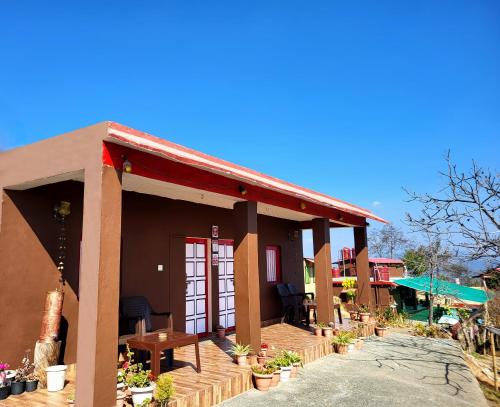 a small house with a red roof at Traveller Hive Kasar Devi in Almora