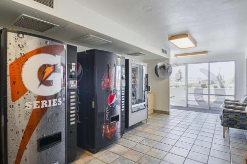 a room with two large soda machines in a room at Motel 6-Laramie, WY in Laramie