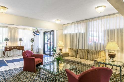 a living room with a couch and chairs and a piano at Americas Best Value Inn Edgewood, MD in Edgewood