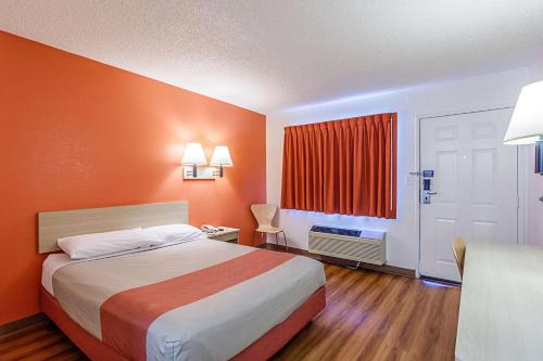a hotel room with a bed and a window at Motel 6 Modesto, CA in Modesto