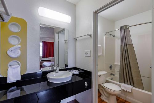 a bathroom with a sink and a toilet at Motel 6 Modesto, CA in Modesto