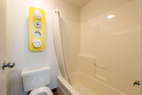 a bathroom with a white toilet and a shower at Motel 6-Waterloo, IA in Waterloo