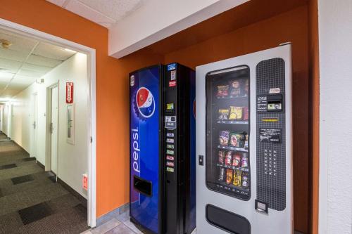 a vending machine in a hallway next to a wall at Motel 6-Waterloo, IA in Waterloo