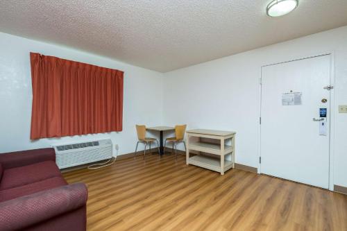 a living room with a couch and a table at Motel 6-Waterloo, IA in Waterloo