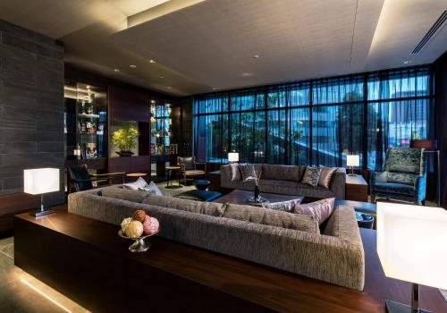 a living room with a couch and a table at Daiwa Roynet Hotel Nagoya Taiko dori Side in Nagoya