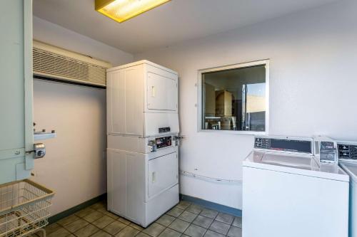 a kitchen with a white refrigerator and a sink at Motel 6-Moses Lake, WA in Moses Lake