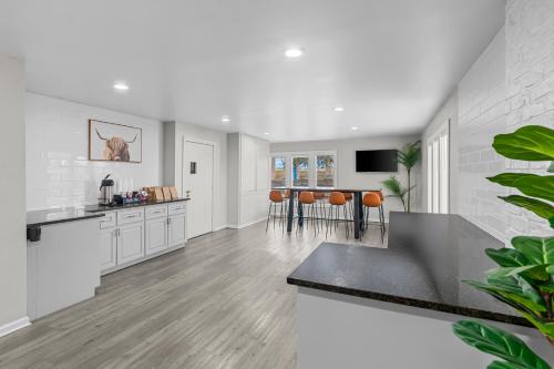 a kitchen and dining room with white walls and wood floors at Americas Best Value Inn Austin in Austin