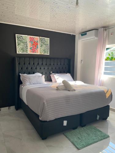 a bedroom with a large bed with a blue headboard at Ramachi Apartment A in Livingstone