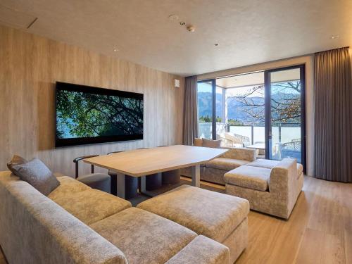 a living room with a couch and a table at Rakuten STAY VILLA Yufuin Onsen in Yufu
