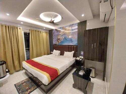 a bedroom with a large bed in a room at Hotel Sea Touch in Digha