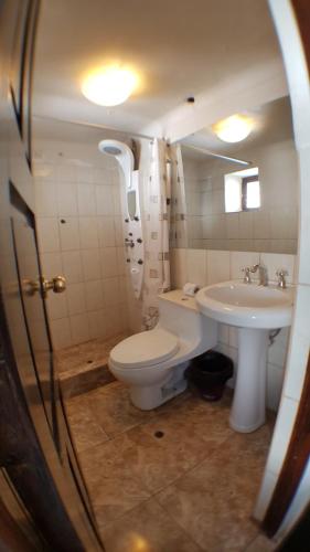 a bathroom with a toilet and a sink at La Cabaña Hotel in Cusco