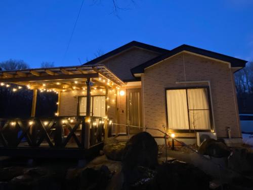 a house with christmas lights on the front of it at コテージオギー in Nasu