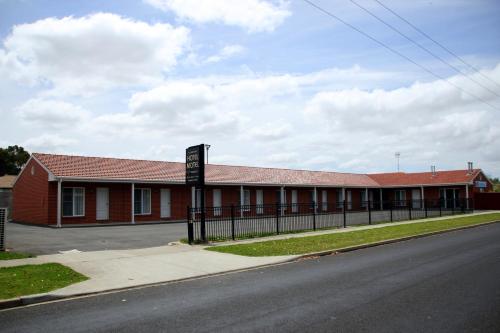 a red building with a sign in front of it at Allansford Hotel Motel in Allansford