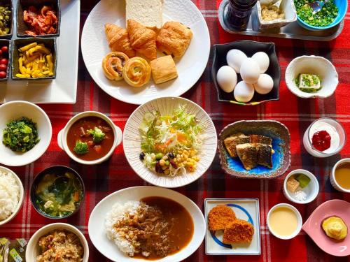 a group of plates of food on a table at Saga City Hotel in Saga