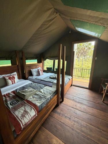 a bedroom with two beds in a tent at Tangi Elephant Camp in Pakwach East