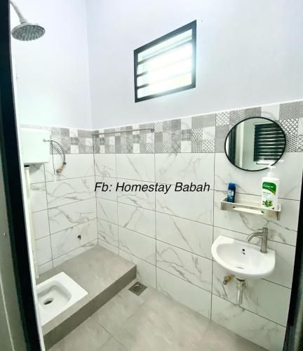 a bathroom with a sink and a toilet at Homestay Babah in Jitra
