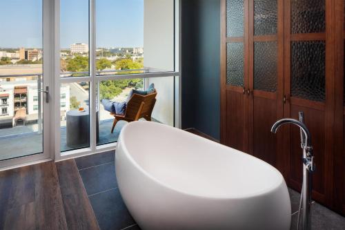 a bath tub in a bathroom with a large window at Thompson San Antonio - Riverwalk, by Hyatt in San Antonio