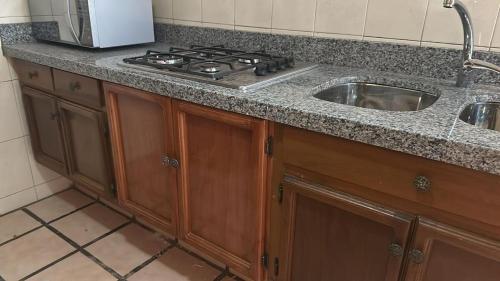 a kitchen counter with a stove and a sink at Not for rent in Mazatlán