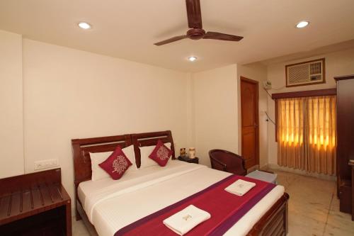 a bedroom with a bed and a ceiling fan at Lloyds Serviced Apartments, Near Music Academy in Chennai