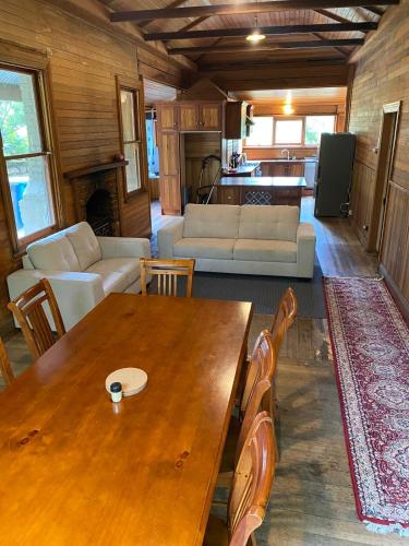 a living room with a wooden table and a couch at Stone Walls in Derby