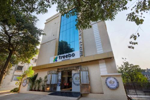 a building with a sign on the side of it at Treebo Sri Krishna Palace in Bhubaneshwar