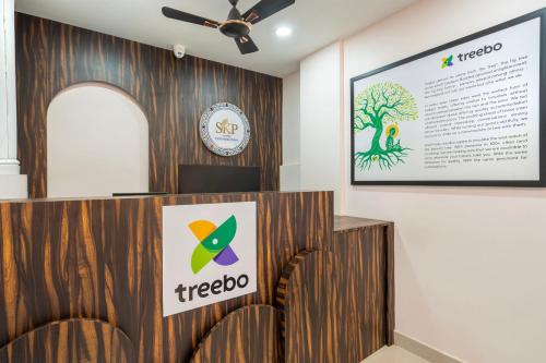 a meeting room with chairs and a sign on a wall at Treebo Sri Krishna Palace in Bhubaneshwar