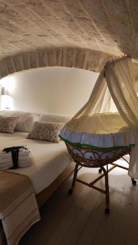 a bedroom with a bed with a canopy at Amalò Guest House in Bari