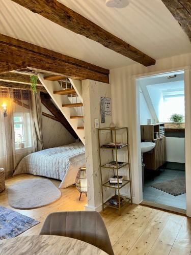a bedroom with a bed and a spiral staircase at Casa Ribeiro Sotao in Bischberg