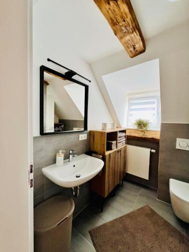 a bathroom with a sink and a mirror at Casa Ribeiro Sotao in Bischberg