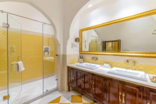 a bathroom with two sinks and a shower at Abheygarh in Khetri