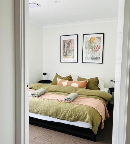a bedroom with a large bed with green sheets at The Baker's Bed - Private 2 King BR Guest Suite in Orange
