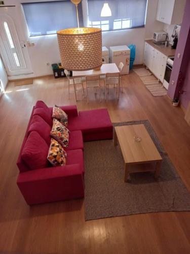 a living room with a red couch and a table at D'ouro Relax - Douro Vinhateiro in Sanfins do Douro
