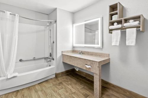 a bathroom with a sink and a shower at Rodeway Inn North Charleston - Ashley Phosphate in Charleston