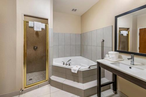 a bathroom with a tub and a sink and a shower at Comfort Inn & Suites Lubbock West in Lubbock