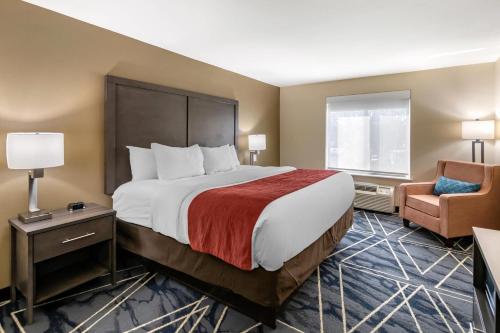 a hotel room with a large bed and a chair at Comfort Inn & Suites Lubbock West in Lubbock