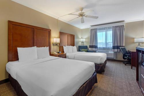 a hotel room with two beds and a television at Comfort Inn & Suites Ocean Shores in Ocean Shores
