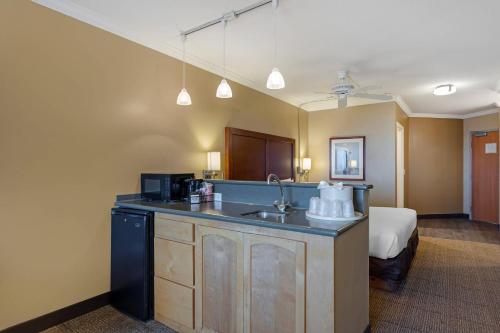 a hotel room with a sink and a bed at Comfort Inn & Suites Ocean Shores in Ocean Shores