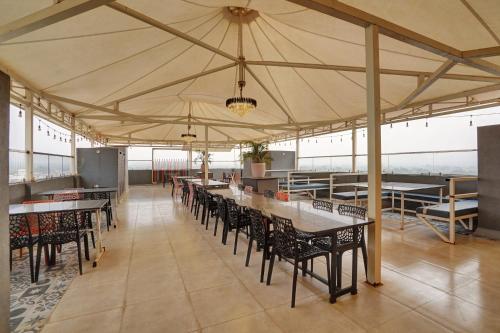 a large tent with tables and chairs in a room at Utkarsh Hotel & Lodging in Jāmkhed